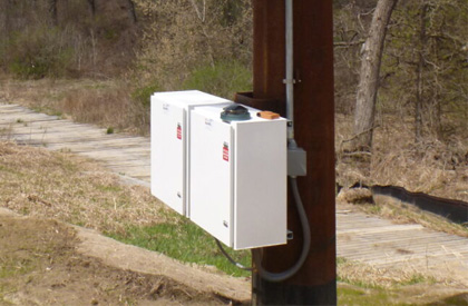 enclosure mounted on a monopole utility tower for aircraft warning lighting