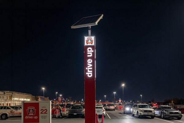 Solar-powered Target Drive Up kiosk with illuminated signage at night